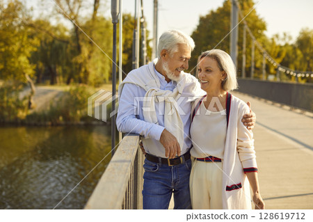 Happy Senior Couple Walking in the City Park 128619712