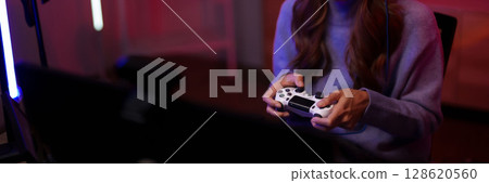 Young adult Asian female gamer hands play video game controller dark room technology entertainment esports leisure fun Young adult Asian female gamer hands play video game controller dark room technology entertainment esports leisure fun 128620560