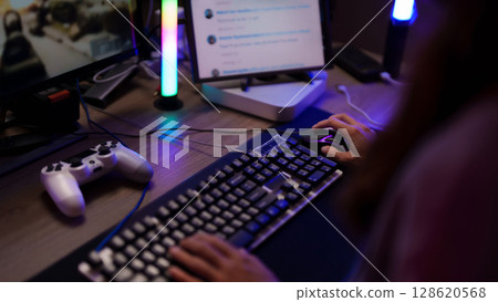 Adult hands typing keyboard using mouse digital technology gaming setup desk space streaming online activity pc 128620568