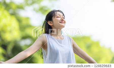 Woman taking a deep breath in the park 128620683
