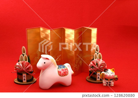 A white horse figurine for a New Year's card for the Year of the Horse on a red background 128620880
