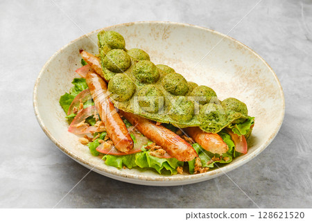 Delicious green waffle with grilled sausage and fresh vegetables served in a stylish bowl 128621520