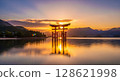 Torii gate reflected on the water at sunrise 128621998
