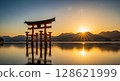 Torii gate reflected on the water at sunrise 128621999