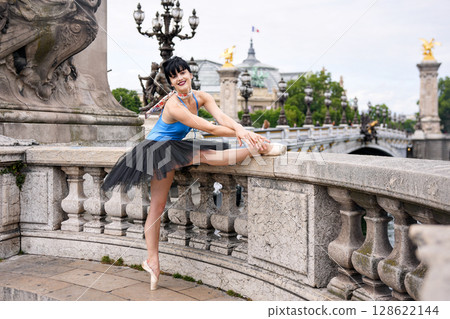 Ballet dancer stretching on Pont Alexandre III bridge in Paris Ballet dancer stretching on Pont Alexandre III bridge in Paris 128622144