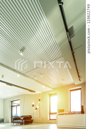 Modern white office with open space and large windows sun sunny light 128622749