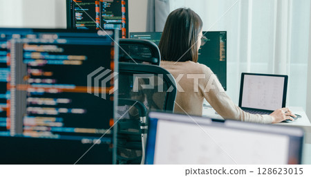 Young adult Asia female freelance eyeglasses typing write prompt AI bot IT app smart program nomad, video game, terminal with coding, user interface, designer, big data center on desktop computer. 128623015