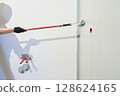 Men's hands paint walls with a roller, work painting on the surface, painting walls in an apartment, repair with white paint. With space to copy. High quality photo 128624165