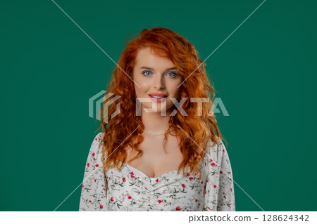 Headshot of kind smiling auburn woman with natural curly hair, joyful expression Headshot of kind smiling auburn woman with natural curly hair, joyful expression 128624342