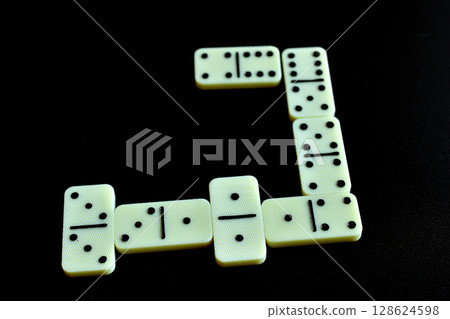 Dominoes are laid out on the table. Dominoes are laid out on the table. 128624598