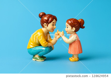 A mother makes a pinky promise to her daughter 128624954