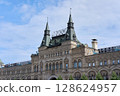 Historic GUM Department Store Facade on Red Square in Moscow Featuring Neo-Russian Stone Arches and Turreted Roofline 128624957