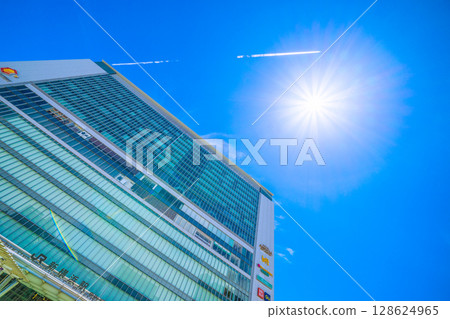 Yokohama cityscape in Japan: Inbound tourists... (bustling) Shin-Yokohama Station, airplane trails, the sun, etc. Towards a new era = July 19th 128624965