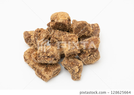 Natural flavored brown sugar lump photographed on white background 128625664