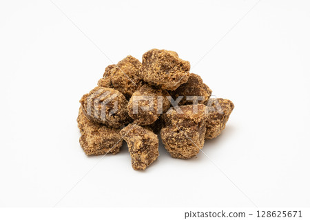 Natural flavored brown sugar lump photographed on white background Natural flavored brown sugar lump photographed on white background 128625671