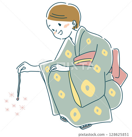 A woman in a yukata playing a sparkler 128625851