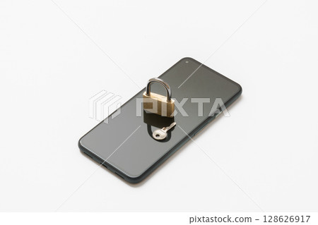 Padlock placed on a smartphone Security image 128626917
