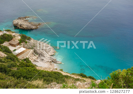private and secluded paradise beach on the Albanian coast, aerial view 128627277