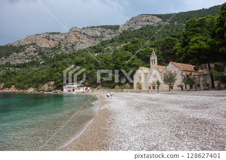 Gusarica Beach in Komiza municipality, on the island of Vis in Adriatic Sea, Croatia Gusarica Beach in Komiza municipality, on the island of Vis in Adriatic Sea, Croatia 128627401