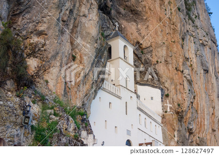 Dabovici, Montenegro - 05.05.2025: Ostrog Monastery, of Serbian Orthodox Church, nestled in rocky hillside 128627497