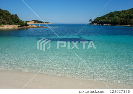 twin islets in front of beach in Ksamil, Albanian rivieira, Ionian sea coastline 128627526