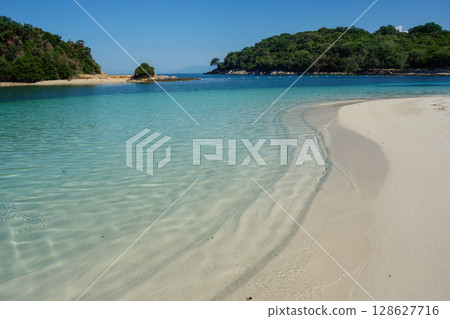 twin islets in front of beach in Ksamil, Albanian rivieira, Ionian sea coastline twin islets in front of beach in Ksamil, Albanian rivieira, Ionian sea coastline 128627716
