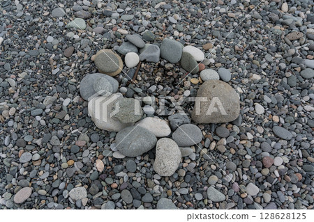A stone bonfire on a stone beach in Batumi 128628125
