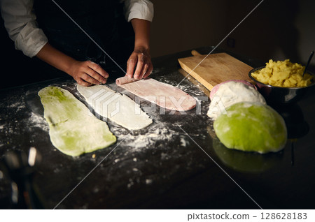 Woman Chef Crafting Colored Dough for Traditional Italian Pasta Woman Chef Crafting Colored Dough for Traditional Italian Pasta 128628183