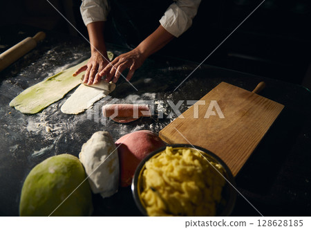 Chef Preparing Homemade Pasta Using Colorful Dough Representing Traditional Italian Cuisine Chef Preparing Homemade Pasta Using Colorful Dough Representing Traditional Italian Cuisine 128628185