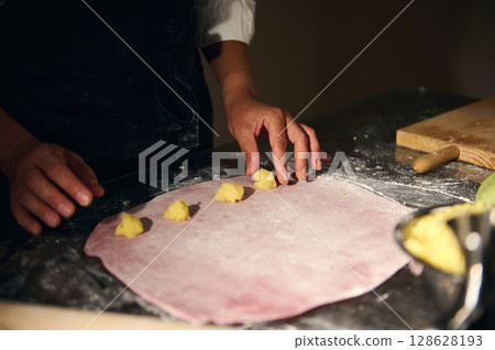 Woman Preparing Homemade Ravioli with Colorful Pasta Dough Woman Preparing Homemade Ravioli with Colorful Pasta Dough 128628193