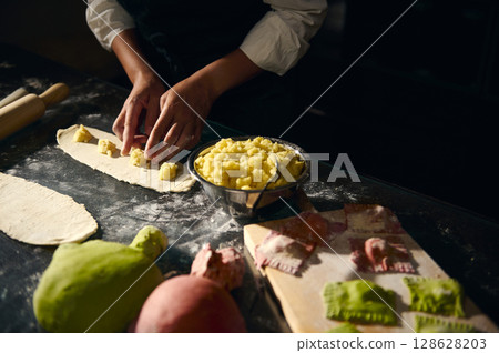Chef Preparing Handmade Pasta Featuring Colorful Italian Flag-Inspired Dough Chef Preparing Handmade Pasta Featuring Colorful Italian Flag-Inspired Dough 128628203