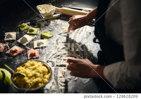 Italian Chef Making Colorful Ravioli with Handcrafted Pasta and Traditional Italian Techniques 128628209