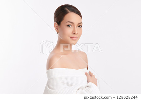 A beautiful young Asian woman with clean, fresh skin against a white background. Skincare, facial treatment, cosmetology, beauty, and spa. An elegant portrait of an Asian woman. A beautiful young Asian woman with clean, fresh skin against a white background. Skincare, facial treatment, cosmetology, beauty, and spa. An elegant portrait of an Asian woman. 128628244