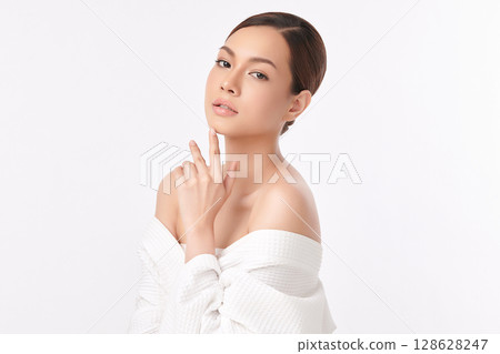 A beautiful young Asian woman with clean, fresh skin against a white background. Skincare, facial treatment, cosmetology, beauty, and spa. An elegant portrait of an Asian woman. A beautiful young Asian woman with clean, fresh skin against a white background. Skincare, facial treatment, cosmetology, beauty, and spa. An elegant portrait of an Asian woman. 128628247