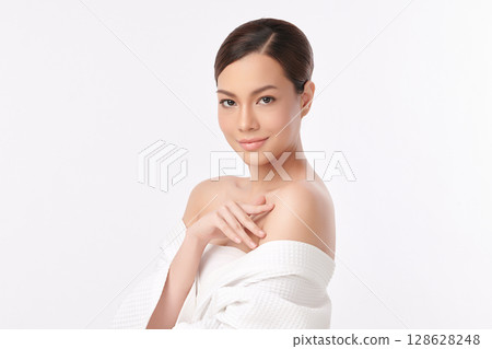 A beautiful young Asian woman with clean, fresh skin against a white background. Skincare, facial treatment, cosmetology, beauty, and spa. An elegant portrait of an Asian woman. A beautiful young Asian woman with clean, fresh skin against a white background. Skincare, facial treatment, cosmetology, beauty, and spa. An elegant portrait of an Asian woman. 128628248