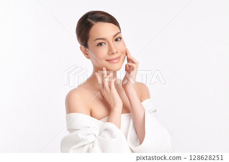 A beautiful young Asian woman with clean, fresh skin against a white background. Skincare, facial treatment, cosmetology, beauty, and spa. An elegant portrait of an Asian woman. A beautiful young Asian woman with clean, fresh skin against a white background. Skincare, facial treatment, cosmetology, beauty, and spa. An elegant portrait of an Asian woman. 128628251