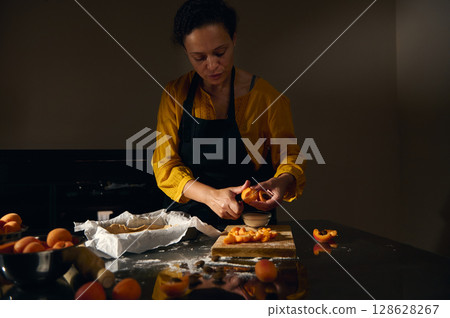 Woman Preparing Fresh Apricot Tart in a Cozy Kitchen Setting Woman Preparing Fresh Apricot Tart in a Cozy Kitchen Setting 128628267
