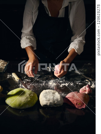 Female Chef Preparing Various Colored Pasta Dough in a Cozy Kitchen Setting Female Chef Preparing Various Colored Pasta Dough in a Cozy Kitchen Setting 128628278