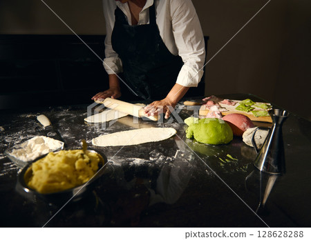 Chef Preparing Colorful Pasta Dough in an Artistic Culinary Scene 128628288