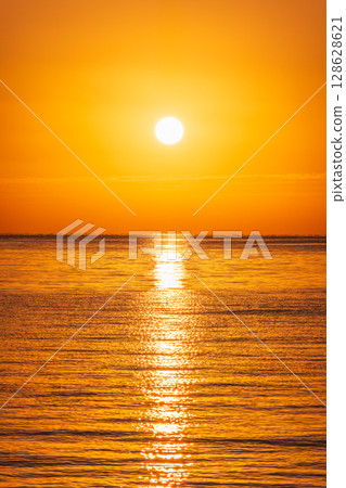 Beautiful red and orange sunrise over the sea. Beautiful red and orange sunrise over the sea. 128628621