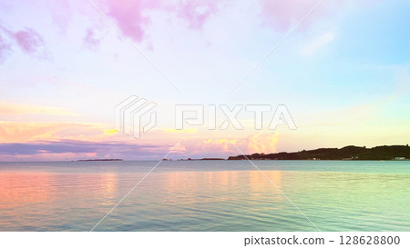 A fantastic tropical sunset, a spectacular view of the tranquil sea and twilight sky, the gradation of the horizon and clouds, Henza Island, Okinawa 128628800