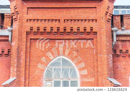 The window of the old mansion 19 century with brown bricks wall The window of the old mansion 19 century with brown bricks wall 128628829