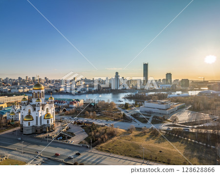 Early spring or autumn Yekaterinburg and Temple on Blood in clear sunset. Aerial view of Yekaterinburg, Russia. Translation of the text on the temple: Honest to the Lord is the death of His saints. 128628866