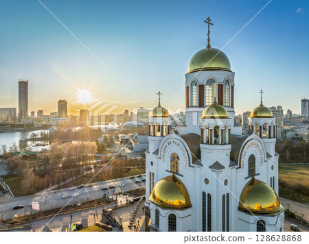 Early spring or autumn Yekaterinburg and Temple on Blood in clear sunset. Aerial view of Yekaterinburg, Russia. Translation of the text on the temple: Honest to the Lord is the death of His saints. Early spring or autumn Yekaterinburg and Temple on Blood in clear sunset. Aerial view of Yekaterinburg, Russia. Translation of the text on the temple: Honest to the Lord is the death of His saints. 128628868