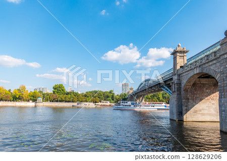 View of the Moscow river embankment, Pushkinsky bridge and cruise ships at sunset. 128629206