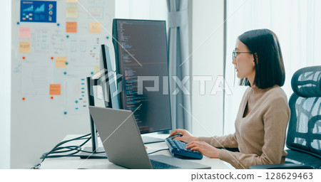 Young adult Asia female freelance eyeglasses typing write prompt AI bot IT app smart program nomad, video game, terminal with coding, user interface, designer, big data center on desktop computer. Young adult Asia female freelance eyeglasses typing write prompt AI bot IT app smart program nomad, video game, terminal with coding, user interface, designer, big data center on desktop computer. 128629463