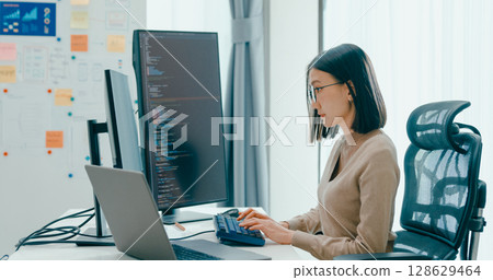 Young adult Asia female freelance eyeglasses typing write prompt AI bot IT app smart program nomad, video game, terminal with coding, user interface, designer, big data center on desktop computer. Young adult Asia female freelance eyeglasses typing write prompt AI bot IT app smart program nomad, video game, terminal with coding, user interface, designer, big data center on desktop computer. 128629464