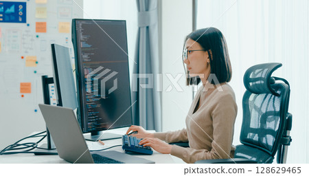 Young adult Asia female freelance eyeglasses typing write prompt AI bot IT app smart program nomad, video game, terminal with coding, user interface, designer, big data center on desktop computer. Young adult Asia female freelance eyeglasses typing write prompt AI bot IT app smart program nomad, video game, terminal with coding, user interface, designer, big data center on desktop computer. 128629465