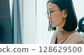 Closeup young adult Asia female freelance eyeglasses typing write prompt AI bot IT app program nomad, video game, terminal with coding, user interface, designer, big data center on desktop computer. 128629500