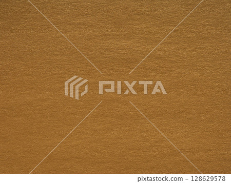 A rich canvas of caramel, the textured surface exudes warmth and the essence of earthy spices 128629578